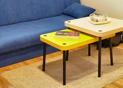 a yellow table with a book on it next to a couch at Rezidenca Erjavec in Notranje Gorice