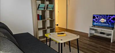 a living room with a couch and a table and a tv at Rezidenca Erjavec in Notranje Gorice