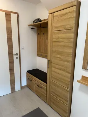 a closet with a wooden door and a drawer at Apartment Zala with Sauna in Kranjska Gora