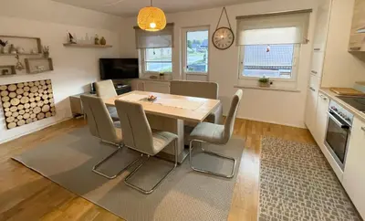 a kitchen and dining room with a table and chairs at Apartment Zala with Sauna in Kranjska Gora