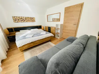 a living room with a bed and a couch at Apartment Zala with Sauna in Kranjska Gora