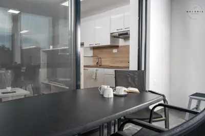 a black table with two mugs on it in a kitchen at Meloria Apartments in Veržej