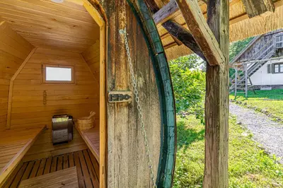 an inside view of a wooden cabin with a door at Vineyard Cottage Skatlar 2 in Srednje Grčevje