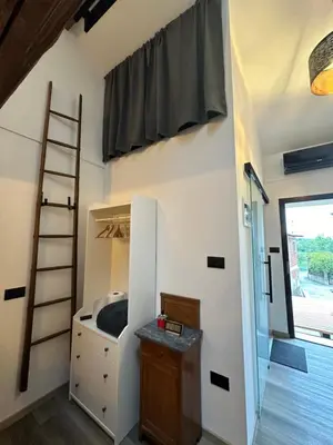 a room with a ladder and a bunk bed at PERLE d ARCONI in Renče