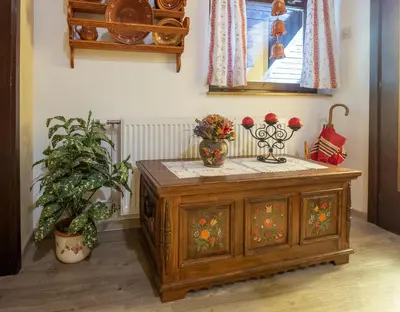 a room with a wooden cabinet with vases on it at Apartment Šporar in Bohinj