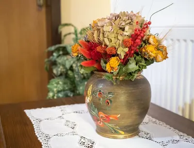 a vase filled with flowers sitting on a table at Apartment Šporar in Bohinj