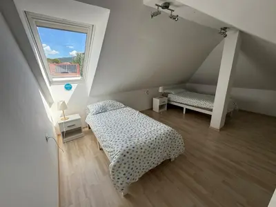 a attic room with two beds and a window at Panoramic View in Postojna