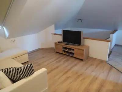 a living room with a flat screen tv on a cabinet at Panoramic View in Postojna