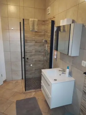 a bathroom with a white sink and a shower at Panoramic View in Postojna
