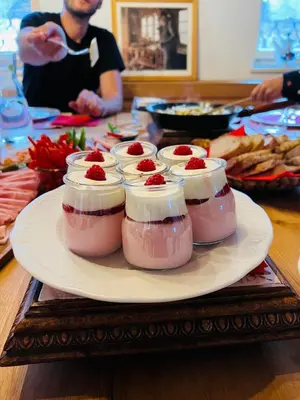 a plate with four desserts in jars on a table at Apartmaji Katrnjek in Bohinj