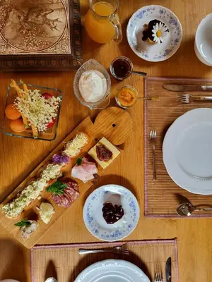 a wooden table with plates of food on it at Apartmaji Katrnjek in Bohinj