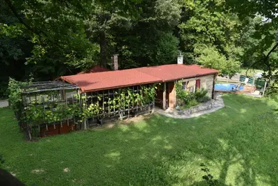 a small house with a red roof and a yard at Log cabin Silec in Šmarje pri Jelšah