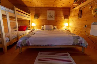 a bedroom with a bed in a wooden cabin at Log cabin Silec in Šmarje pri Jelšah
