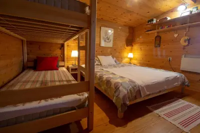 a bedroom with two bunk beds in a cabin at Log cabin Silec in Šmarje pri Jelšah