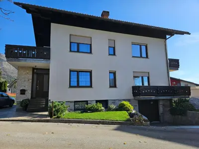 a white house with black windows and a driveway at Apartment Josipina in Preddvor