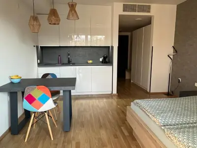 a kitchen with a table and a kitchen with a bed at TB7 Bled in Bled
