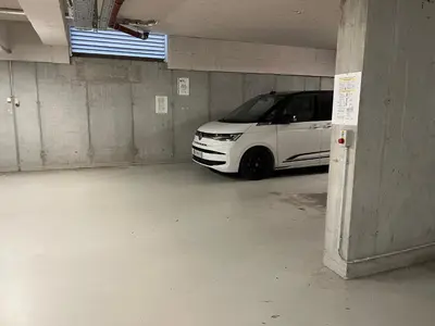 a white car parked in a parking garage at TB7 Bled in Bled