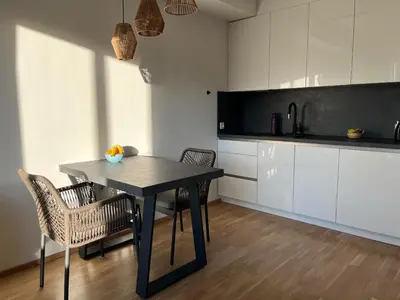 a kitchen with a table and chairs in a room at TB7 Bled in Bled