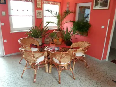 a dining room with a table and chairs at Apartmaji in sobe Kocjančič in Podčetrtek