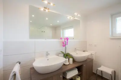 a bathroom with two sinks and a mirror at Apartma Bled in Bled