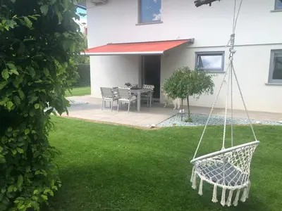 a swing in the yard of a house at Apartma Bled in Bled
