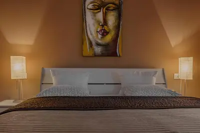 a bedroom with a bed with a painting on the wall at Apartma Bled in Bled
