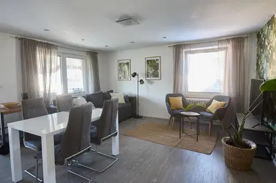a living room with a couch and a table and chairs at Apartma Bled in Bled