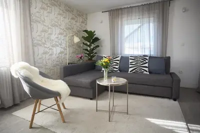 a living room with a couch and a table at Apartma Bled in Bled
