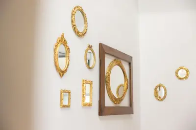 a group of mirrors hanging on a wall at Karlovška Duplex Urban Apartment in Ljubljana