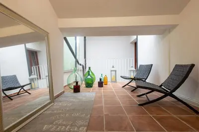 a hallway with chairs and a large mirror at Karlovška Duplex Urban Apartment in Ljubljana