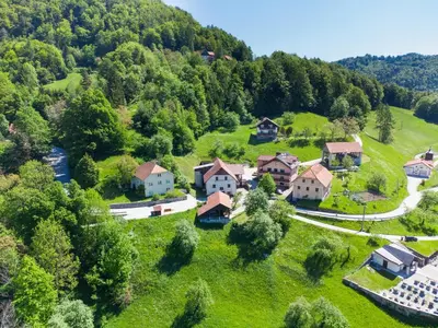 an aerial view of a village in the mountains at Kmetija Na Čendavš in Cerkno