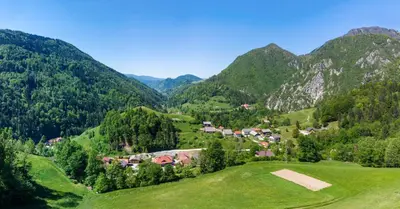 a small village in a valley in the mountains at Kmetija Na Čendavš in Cerkno