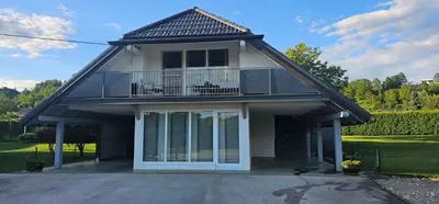 a house with a balcony and a porch at Apartment ZOI in Ptuj