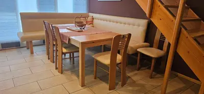 a wooden table and chairs in a room at Apartment ZOI in Ptuj