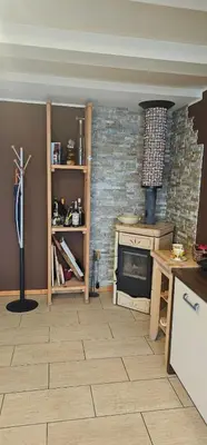 a kitchen with a stove and a brick wall at Apartment ZOI in Ptuj