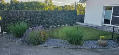 a garden with plants in front of a fence at Apartment ZOI in Ptuj
