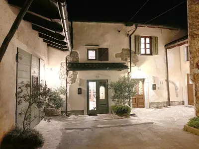 an old building with a door in a courtyard at Rural Family Escape in Vipava