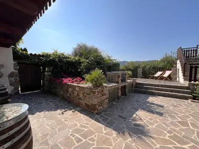 a patio with a retaining wall and some plants at Rural Family Escape in Vipava
