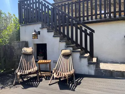 two chairs sitting on a deck with a staircase at Rural Family Escape in Vipava