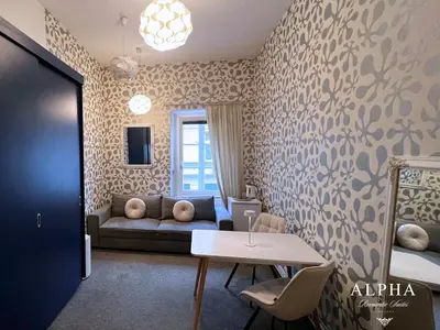 a living room with a couch and a table at Alpha Romantic Suites Ljubljana in Ljubljana