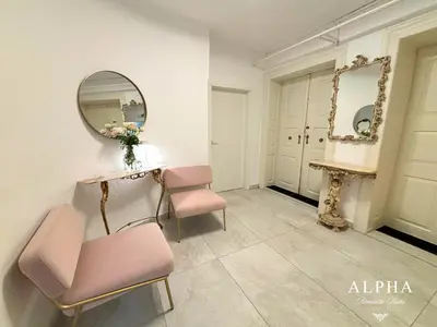 a room with two pink chairs and a mirror at Alpha Romantic Suites Ljubljana in Ljubljana