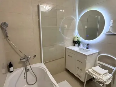 a bathroom with a tub and a shower and a sink at Alpha Romantic Suites Ljubljana in Ljubljana