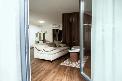 a living room with a white couch and a table at Anur Apartment in Ptuj