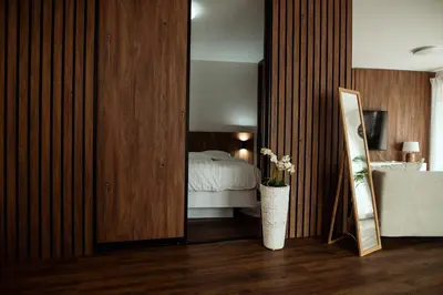 a bedroom with a bed and a mirror at Anur Apartment in Ptuj