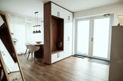 a living room with a table and a door to a room at Anur Apartment in Ptuj