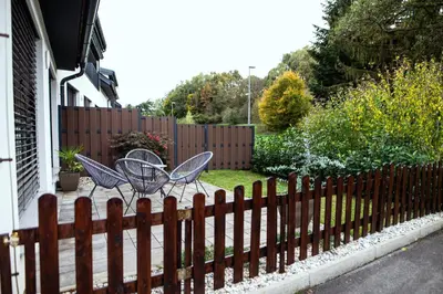 two chairs and a table on a fence at Anur Apartment in Ptuj