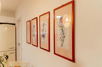 a row of framed pictures on a wall at Anur Apartment in Ptuj