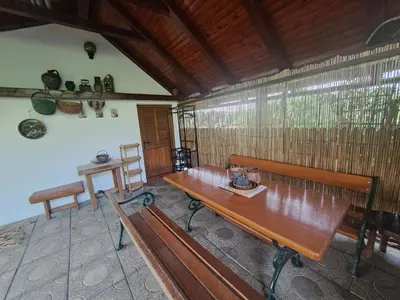 a room with a wooden table and benches in it at Hiška Janko in Metka in Ptuj
