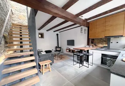 an open kitchen and dining room with a wooden staircase at Tranquil Escape in Vipava