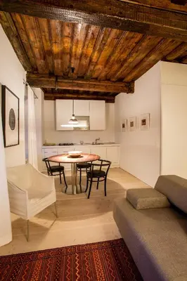 a kitchen and dining room with a table and chairs at FishSquare in Ljubljana